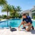 Professional pool technician servicing a crystal-clear residential pool in Boca Raton, FL